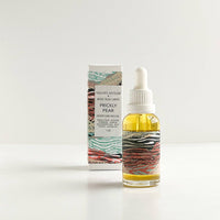 Bottle of Prickly Pear skincare product with packaging on a white background