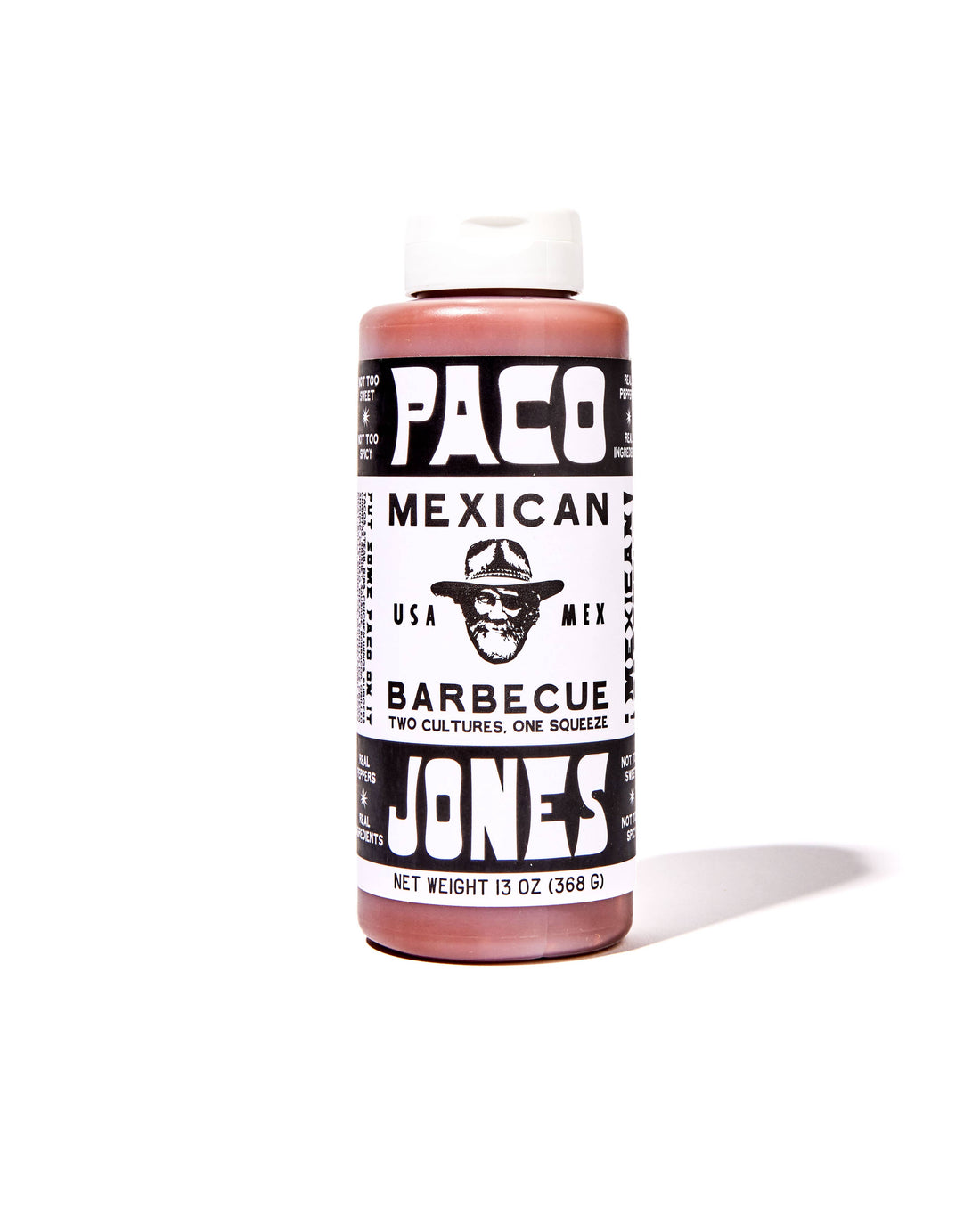 A bottle of Paco Mexican Barbecue Sauce by Paco Jones, featuring a black and white label with a cowboy hat logo, on a white background with a soft shadow.