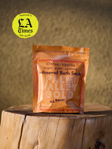 Palm Valley Gold Mineral Bath Soak package on a wooden surface with a blurred background