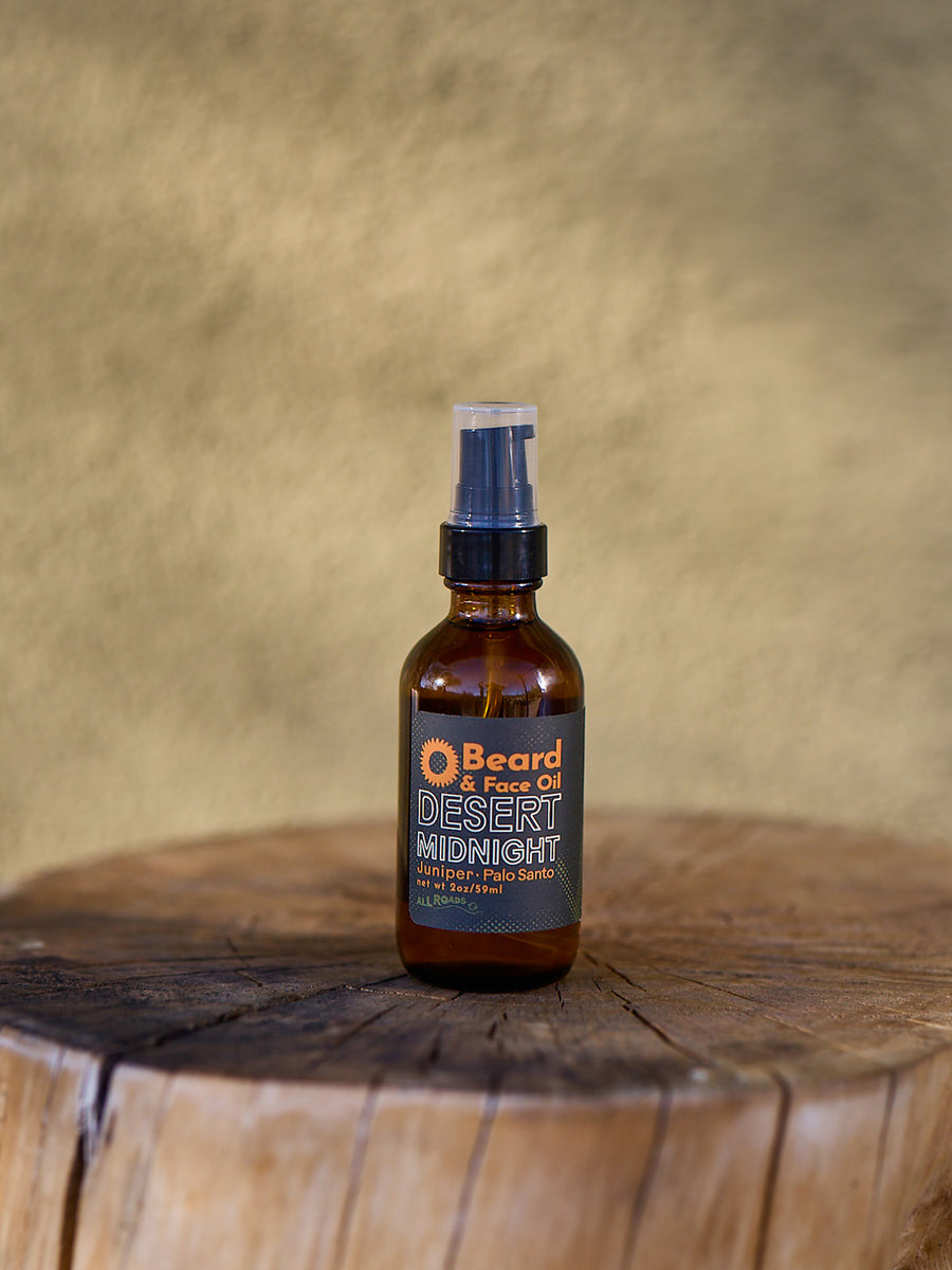 Brown spray bottle labeled 'Desert Midnight' on a wooden surface with a beige background