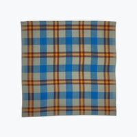 Plaid fabric with blue and orange pattern on a white background