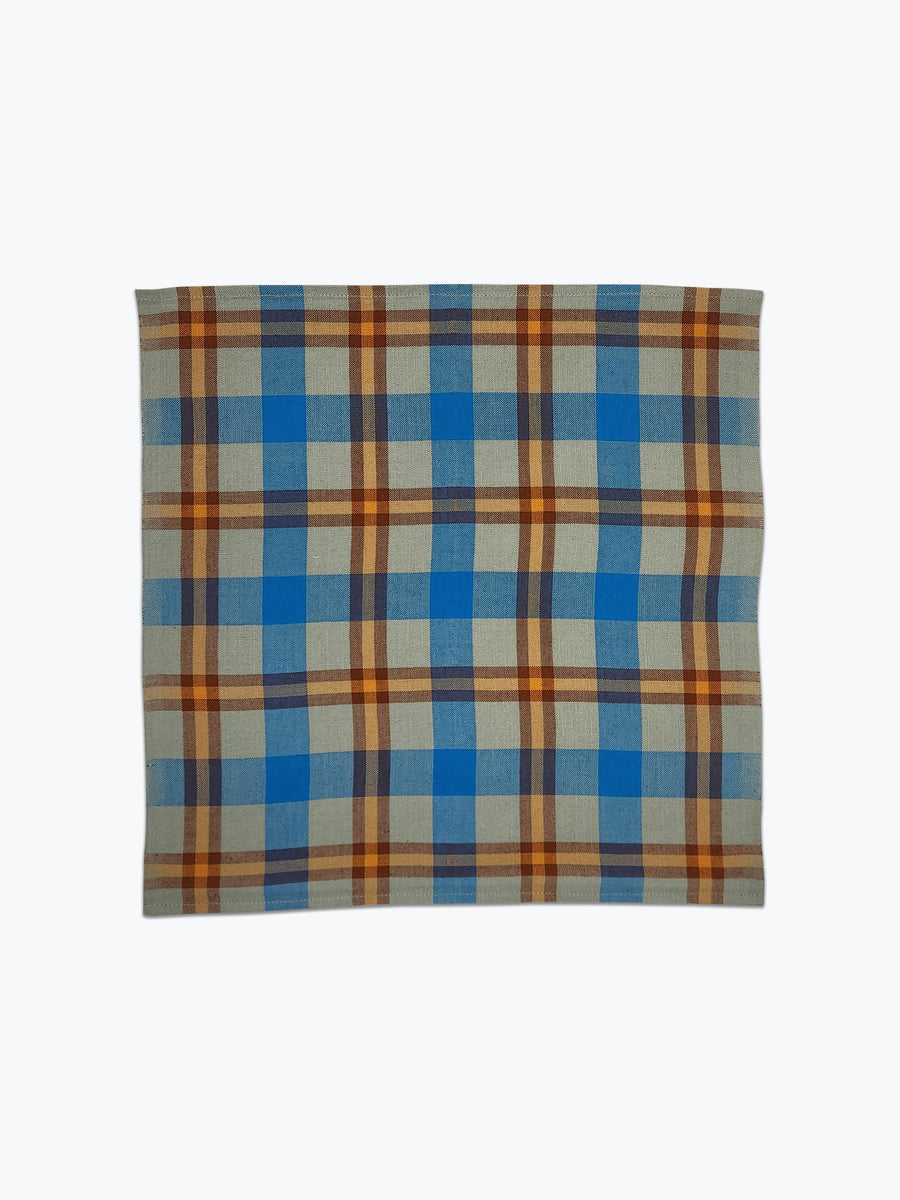 Plaid fabric with blue and orange pattern on a white background