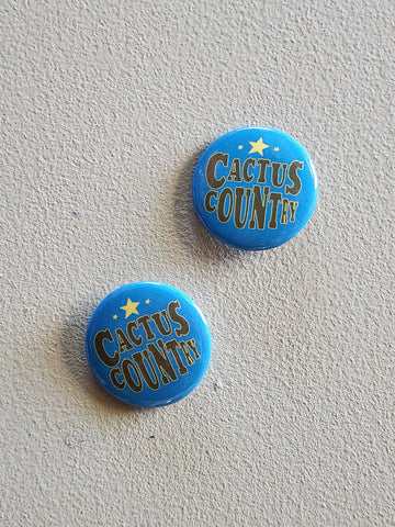 Two blue buttons with 'Cactus Country' text on a light gray background