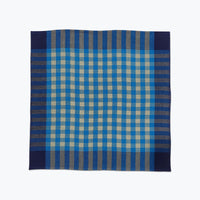 Blue and beige checkered fabric napkin on a white background