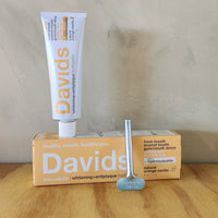 Davids orange vanilla toothpaste. Comes with a metal tube squeezer. 