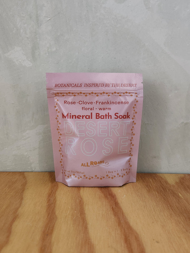 A pink pouch of mineral bath salts containing essential oils and scent of rose and clove.