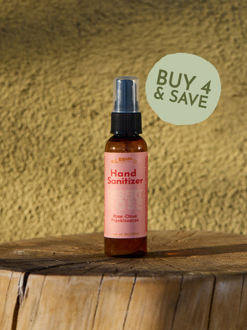 Hand sanitizer bottle on a wooden surface with a textured yellow wall background