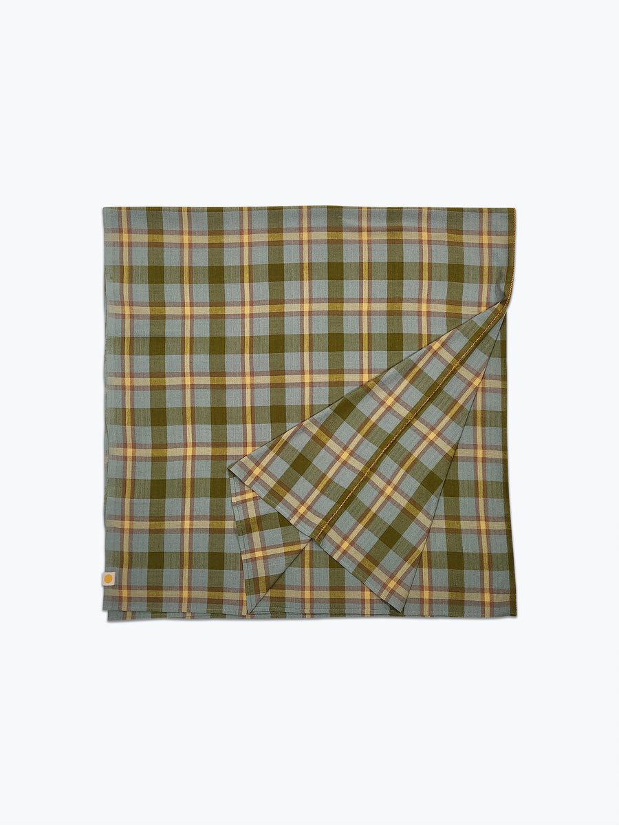 Plaid tablecloth in shades of greens and butter yellow.