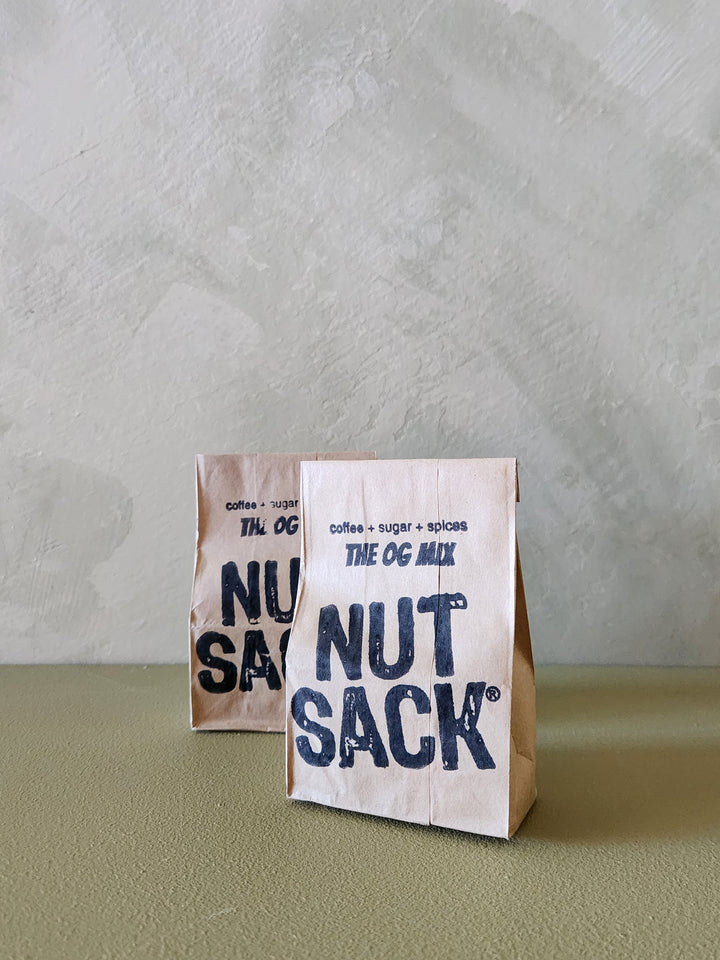 Two 'Nut Sack' packages on a textured surface with a neutral background