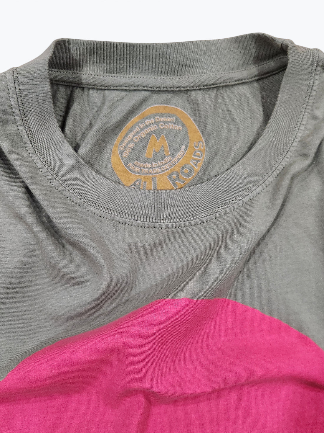 Green and pink shirt with a brand logo on the collar