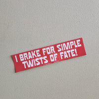 Red bumper sticker with white text on a gray background