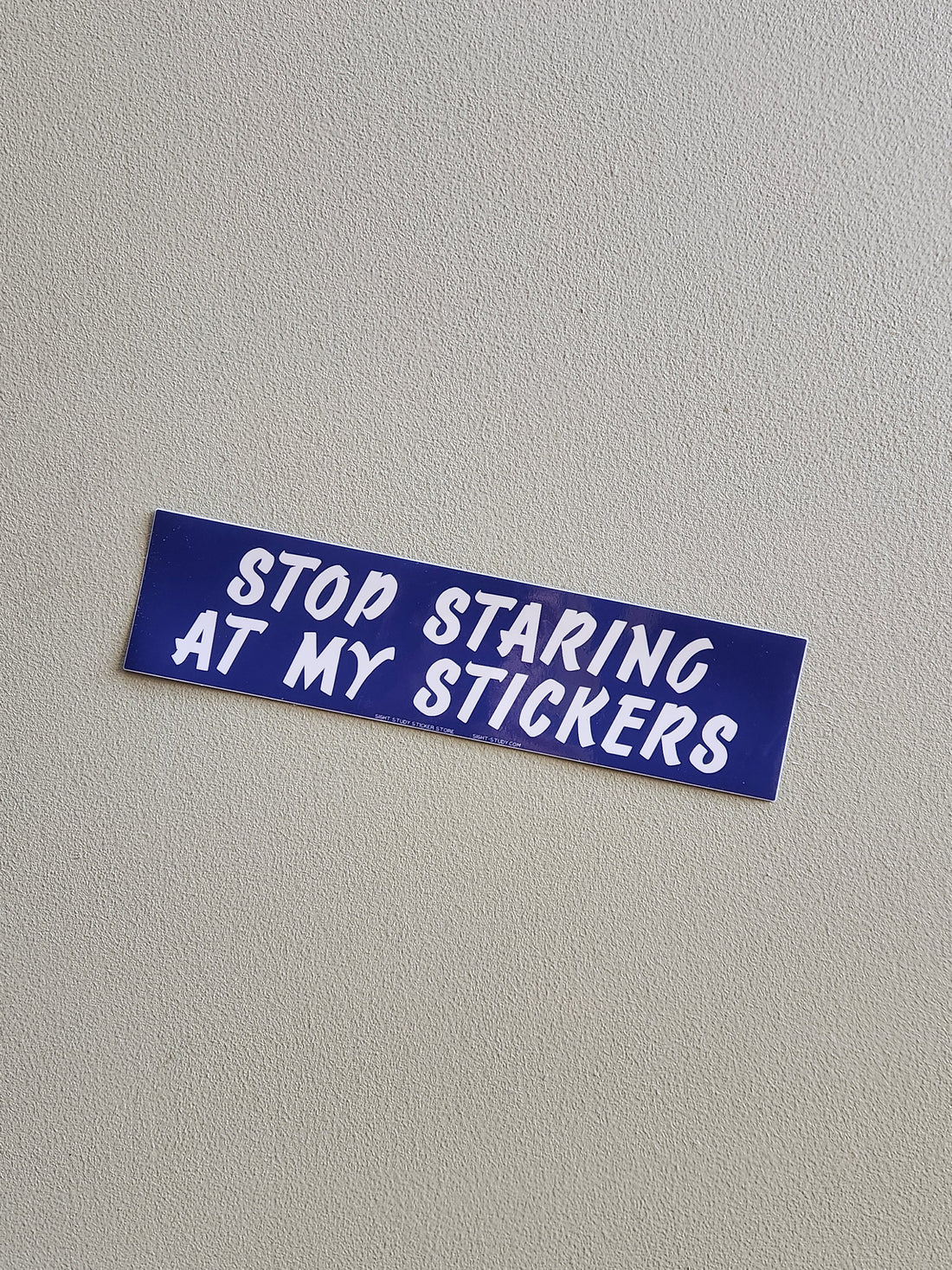 Blue sticker with white text &