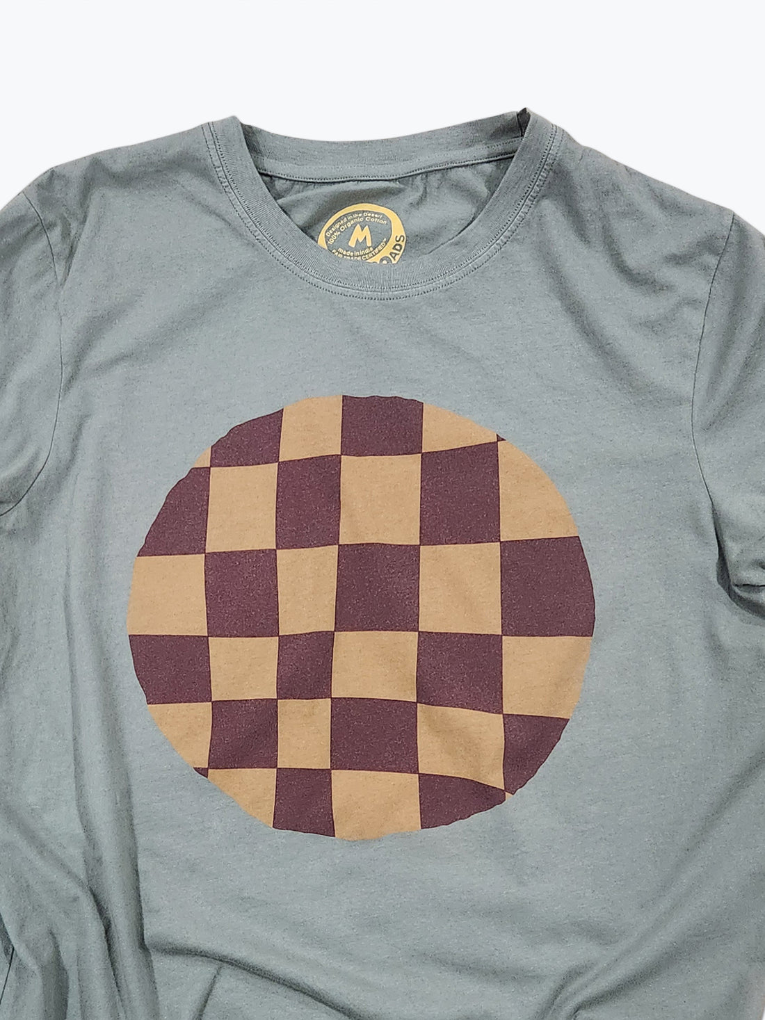 Gray t-shirt with a large brown and red checkered circle design on a white background