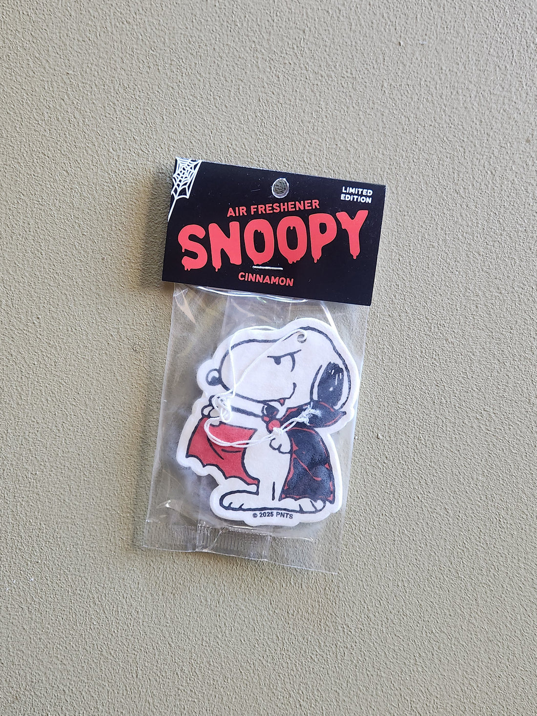 Snoopy air freshener packaging on a plain background