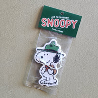 Snoopy air freshener with green hat on a clear background