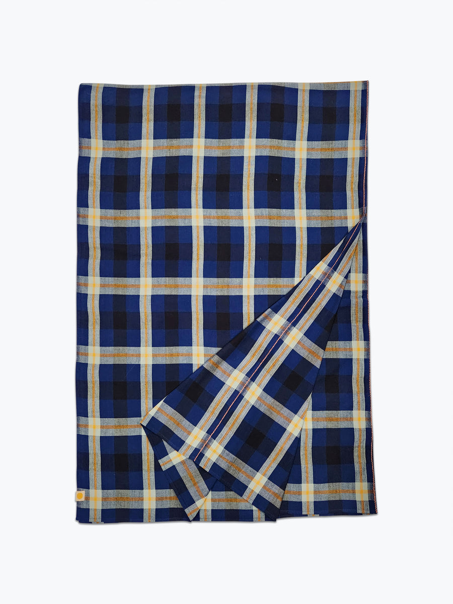 Plaid tablecloth in dark blue, black and sage green.