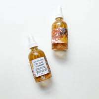 Two bottles of 'Yellow Flower' on a white background