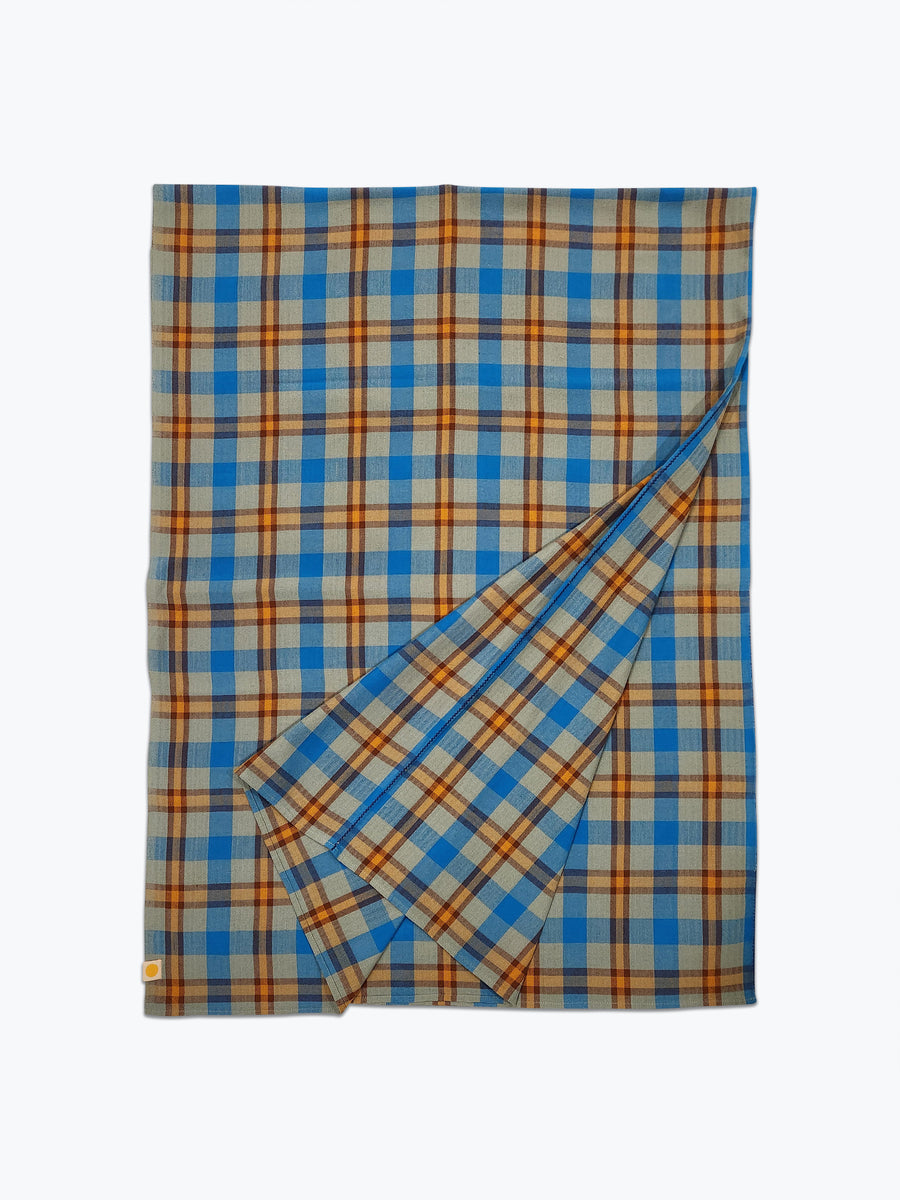 Plaid tablecloth in sage green, ochre yellow with a pop of blue.