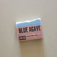Bar of soap with 'Blue Agave' and 'AWSB' branding on a light gray background