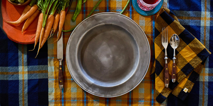 Plated dish with cutlery on a checkered tablecloth