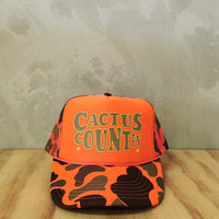 Hi-vis orange camo foam trucker hat with Cactus Country text. 