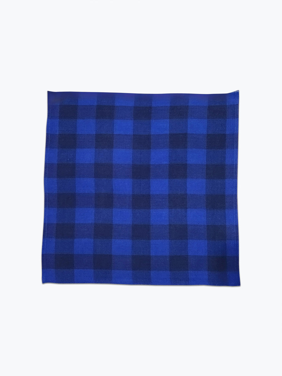 Large scale gingham plaid cotton napkin in 2 tonal blue colors.