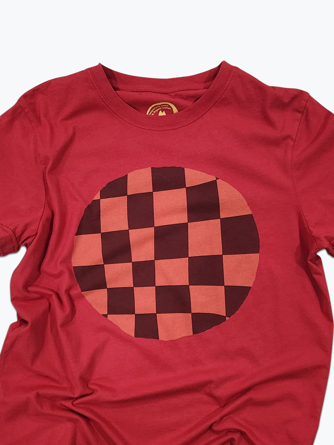 Red t-shirt with a checkered circle design on a white background