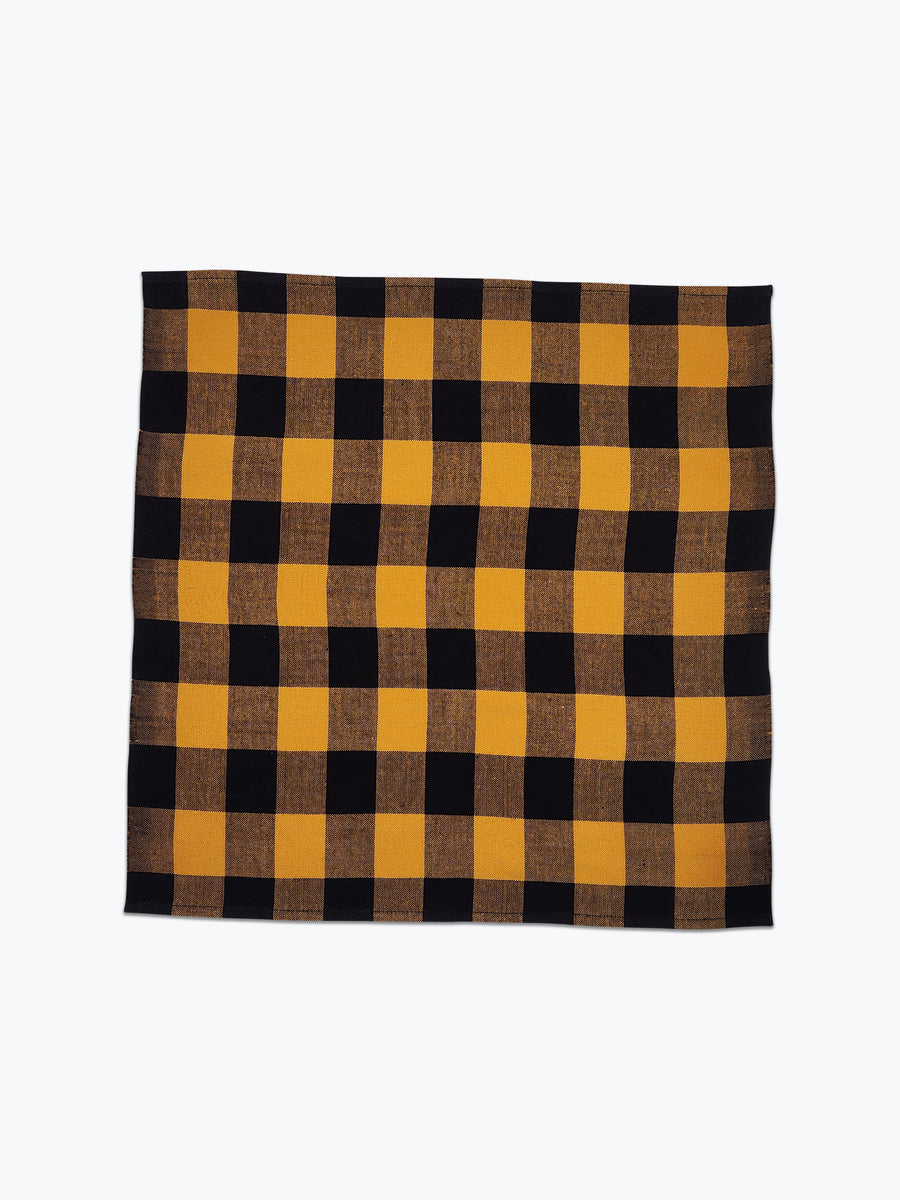 Large scale gingham plaid napkin in ochre yellow and black.