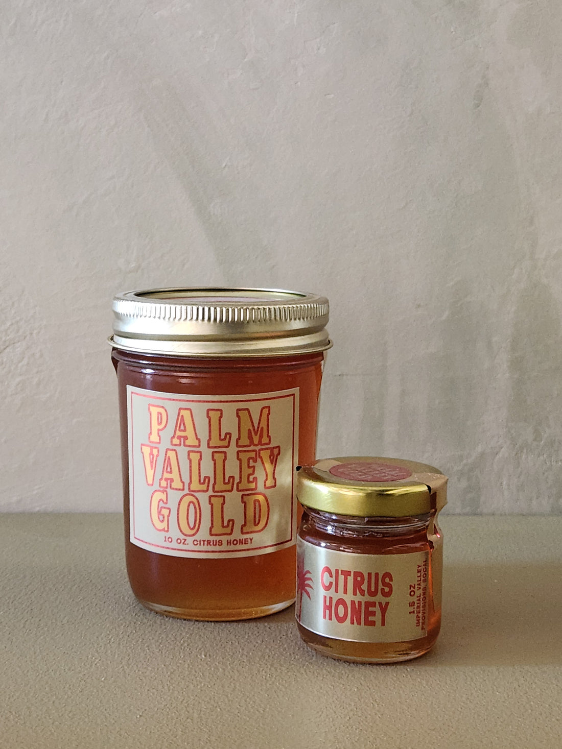 Two jars of honey labeled &