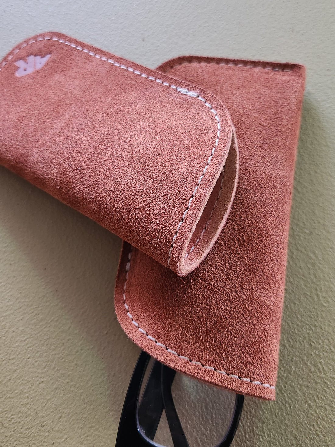 Suede eyeglass cases on a light gray background