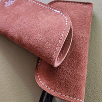 Suede eyeglass cases on a light gray background