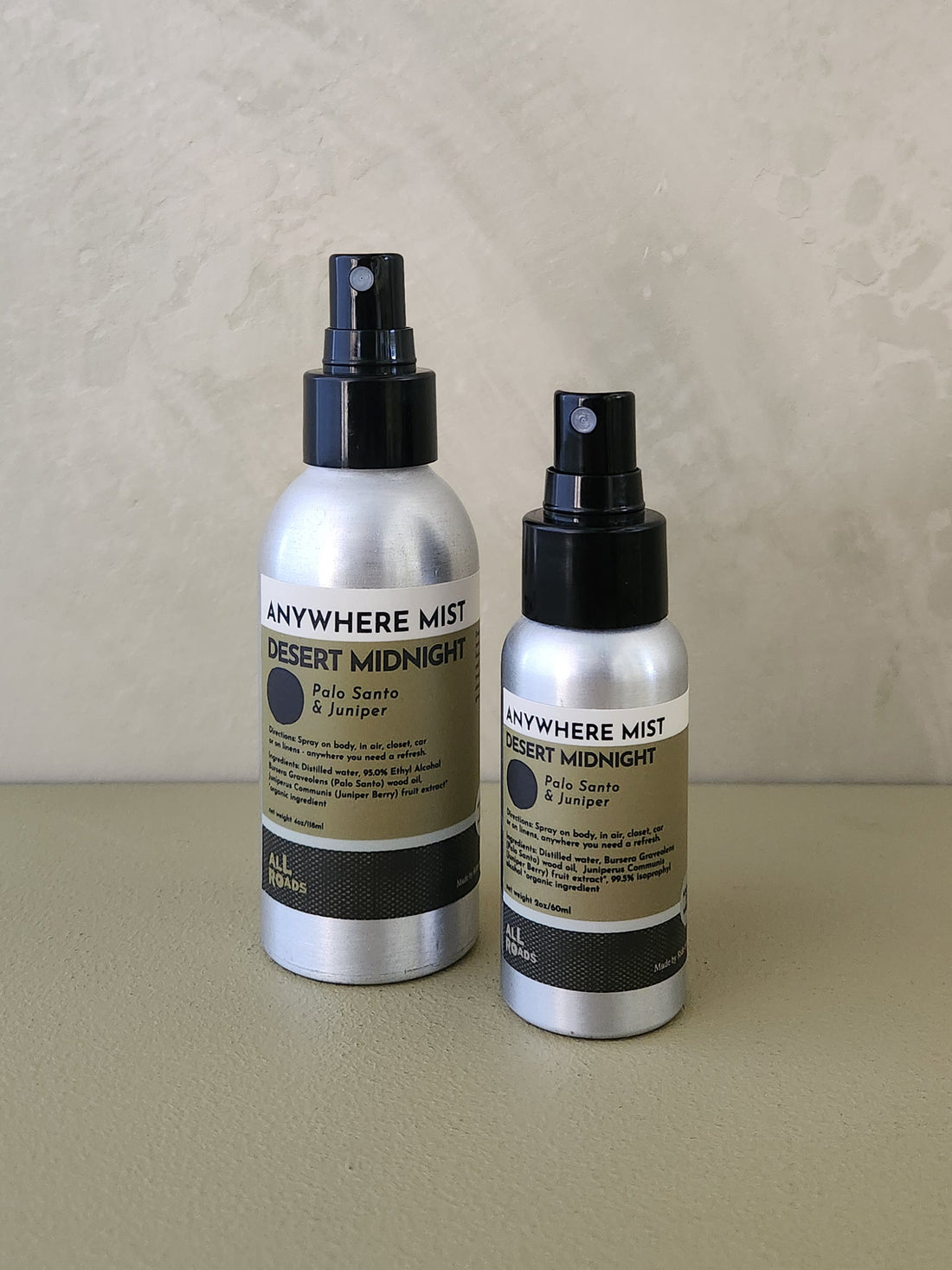Two silver spray bottles of &