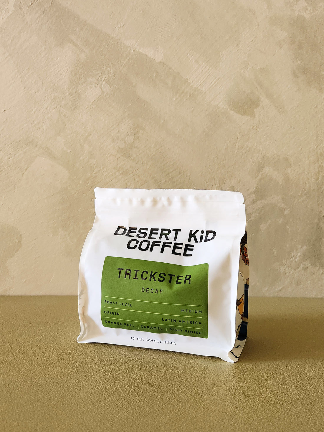 Desert Kid Coffee Trickster Decaf package on a beige background