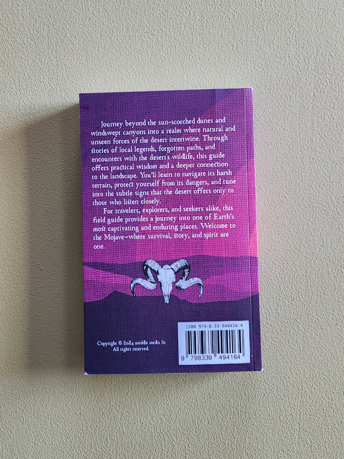 Purple book cover with text and a barcode on a gray background
