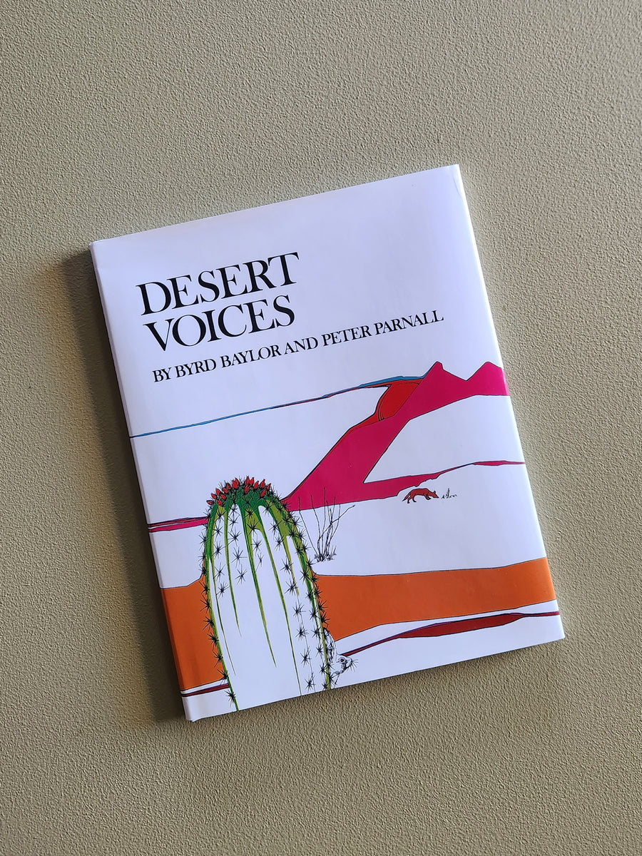 Book titled 'Desert Voices' by Hyrd Baylor and Peter Parnall on a beige background