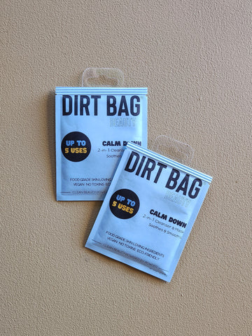 Two packages of 'Dirt Bag' on a beige background