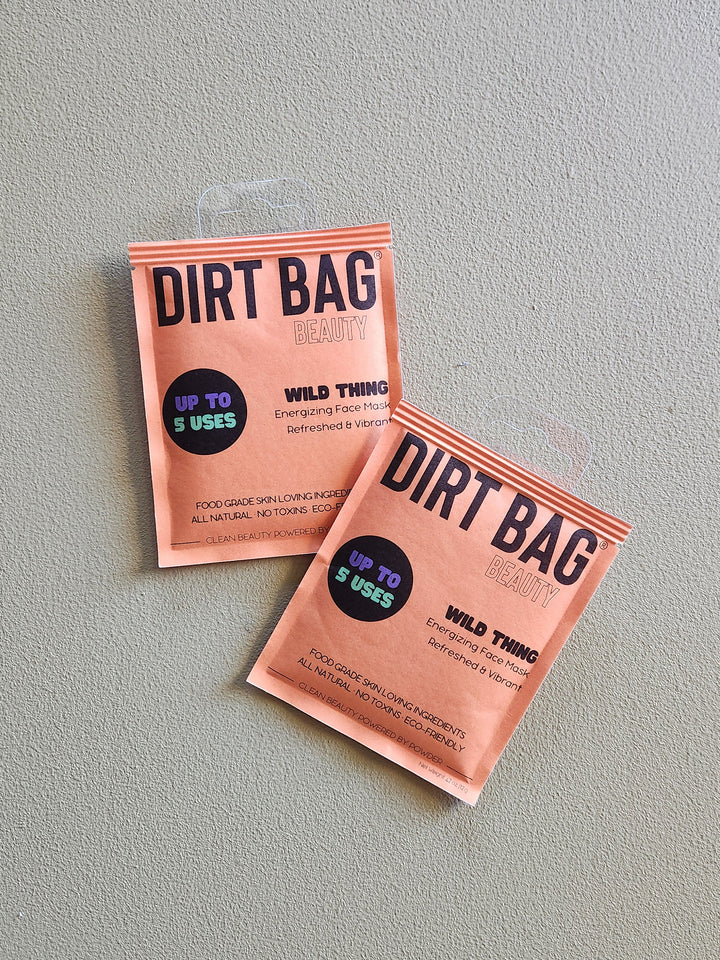 Two 'Dirt Bag Beauty' face mask packets on a gray background
