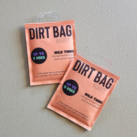 Two 'Dirt Bag Beauty' face mask packets on a gray background