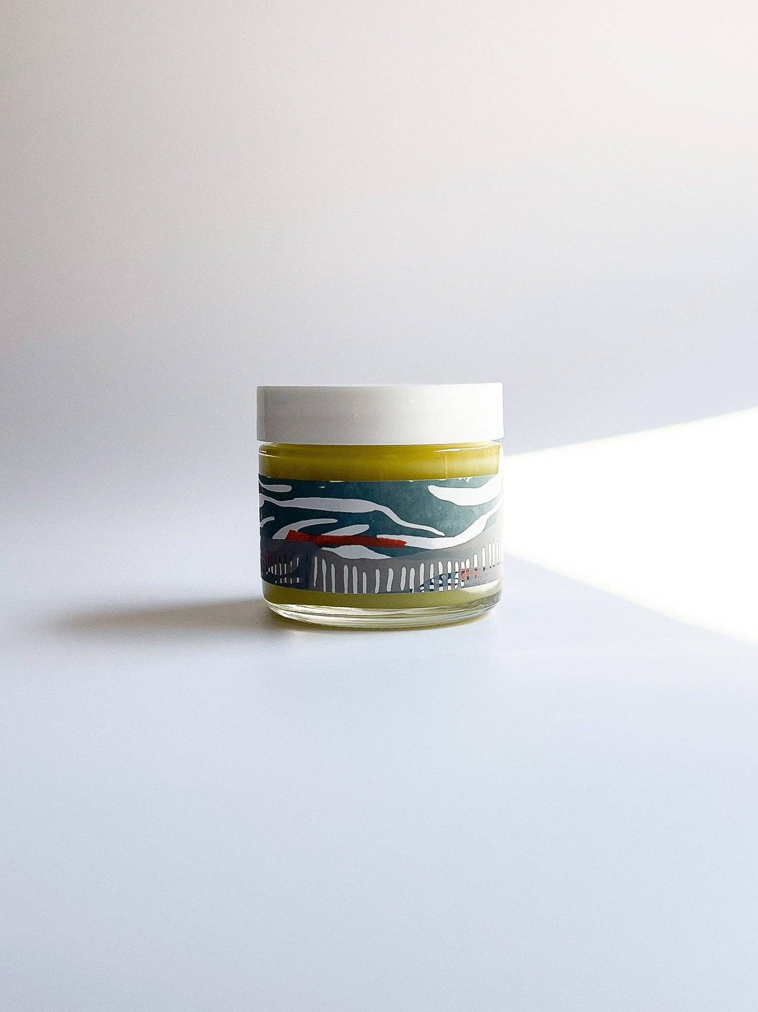Small jar with a label on a white background