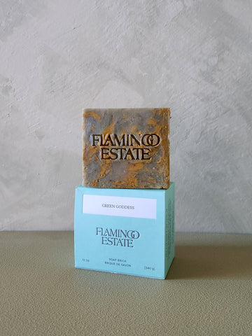 Bar of soap with 'Flamingo Estate' branding on a gray background
