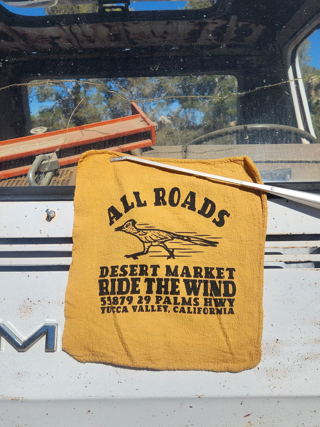 Yellow towel with text and logo on a vehicle interior