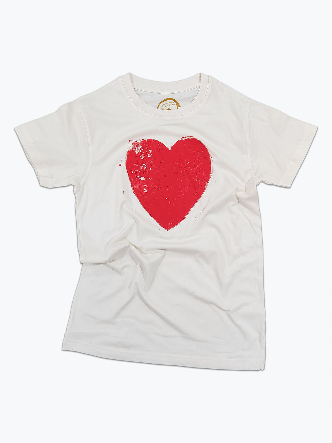 A white organic cotton t-shirt with a block print red heart design on the front.