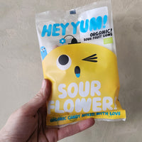 A bag of sour gummy flower and rabbit shaped candies. 