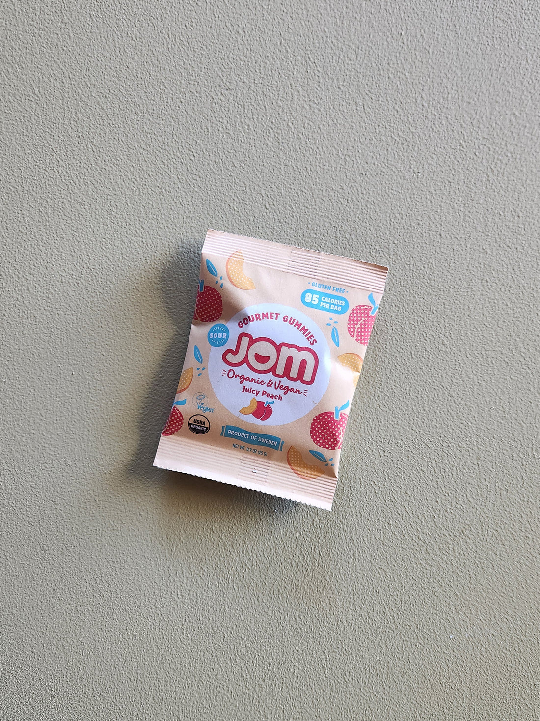 Jom snack package on a gray background