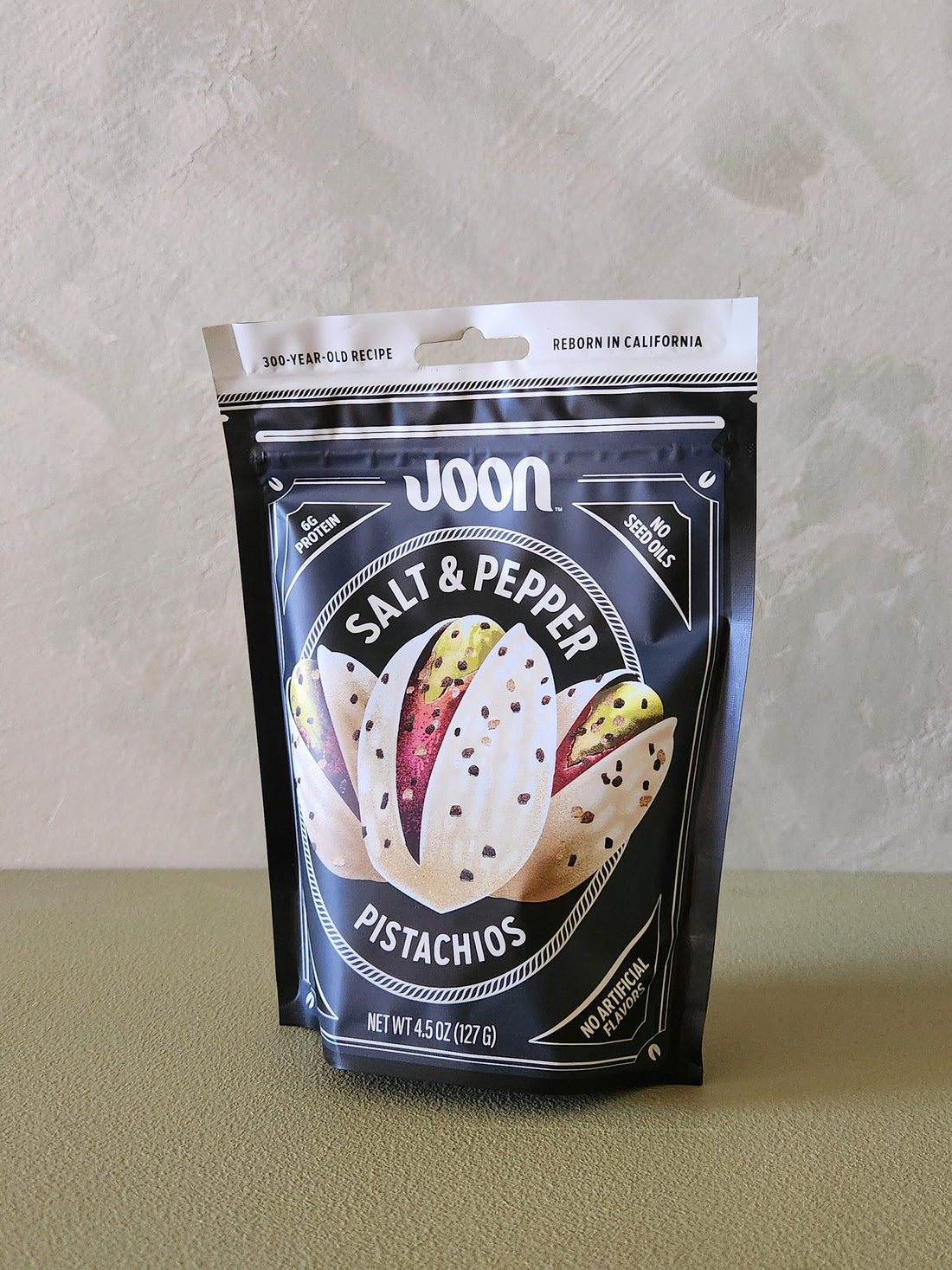 Packaging of Joon Salt & Pepper Pistachios on a neutral background
