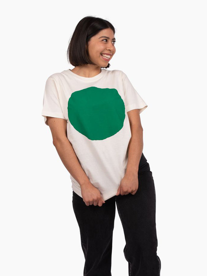 Person wearing a white t-shirt with a large green circle on a white background