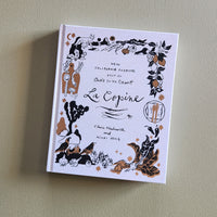 Book titled 'La Copine' with decorative cover on a plain background