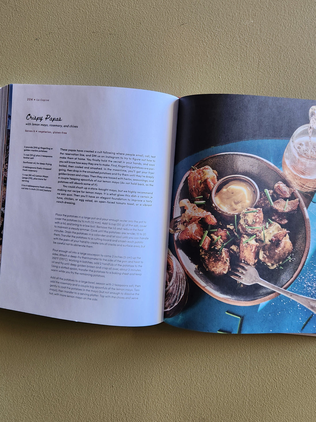 Open cookbook showing a recipe for Crispy Poppers with an image of the dish on a blue background.