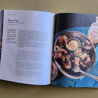 Open cookbook showing a recipe for Crispy Poppers with an image of the dish on a blue background.