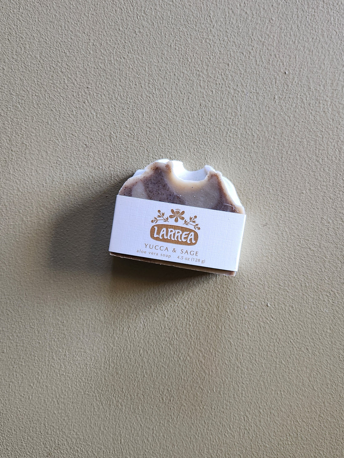 Bar of soap with a label on a gray background